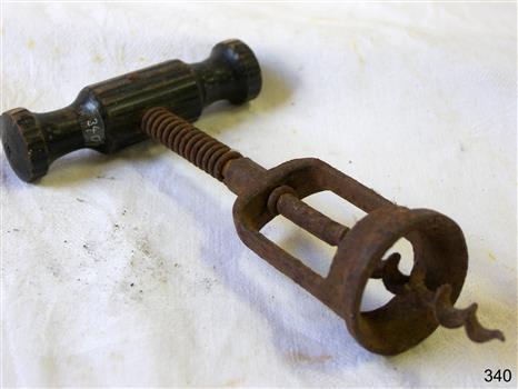 Sturdy professional looking corkscrew with a wooden handle and metal mechanism.