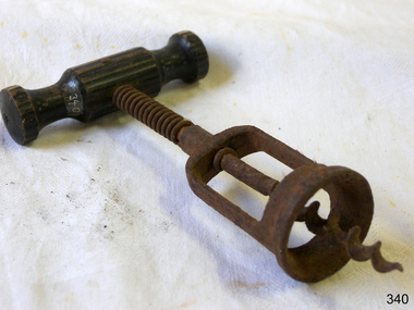 Sturdy professional looking corkscrew with a wooden handle and metal mechanism.