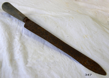 Carving knife with long slender blade and wooden handle.