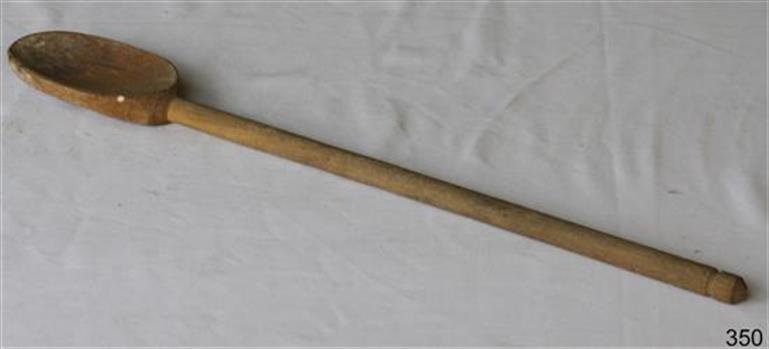 Wooden spoon has an oval shaped bowl and long handle