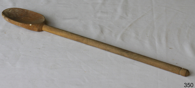 Wooden spoon has an oval shaped bowl and long handle
