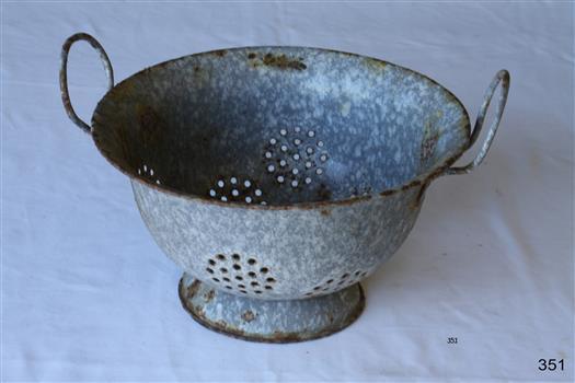 Mottled blue enamel colander with two thin handles.