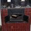 Iron combustion stove with drop-down access to fuel box and double doors for the oven. Imbedded in surrounding brickwork.
