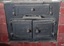 Cast iron stove with three positions for cooking on top, fire box below with ash tray, and oven below, and damper