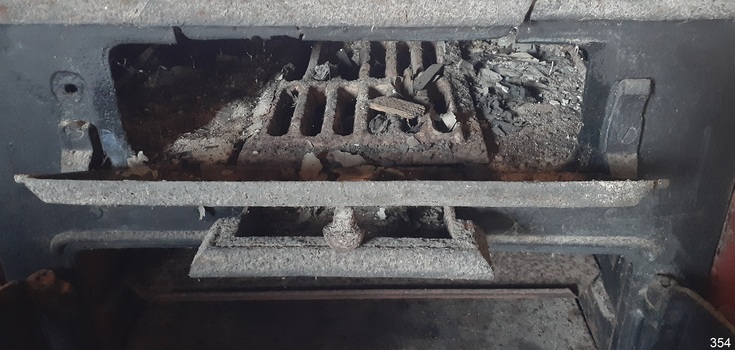 The firebox has a grate inside to support the fuel and filter the ash into the tray below