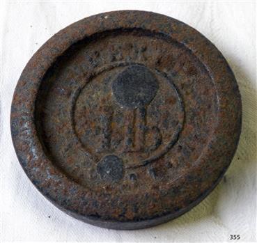 Round metal weight with inscription 