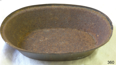 Oval metal pie dish. Badly corroded all over.