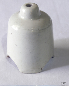 Off white ceramic pie funnel, with three scalloped edges on base and hole on the top..