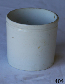 A white glazed ceramic jar base without a lid, with a single groove around circumference near lip.