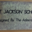 Metallic silver plaque with black text naming maker and model title