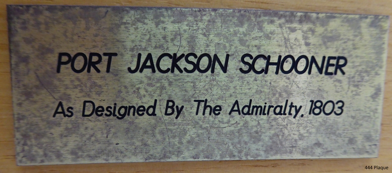Metallic silver plaque with black text naming maker and model title