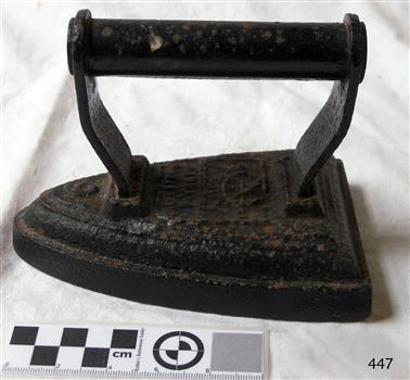 Old fashioned iron. Metal includes handle. Significant rust.