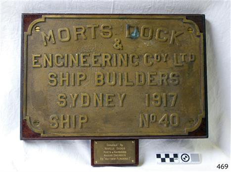Mounted brass nameplate identifies ship builder and ship's number. Another plaque refers to the donor.