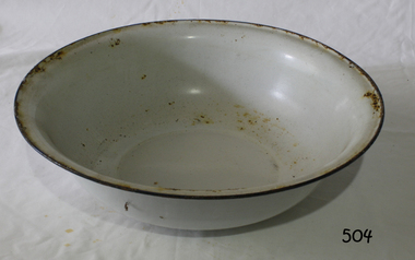 A round metal bowl with white enameled finish and blue rim around the top edge.