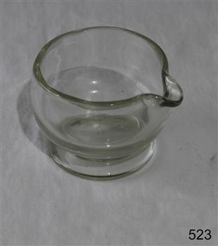 Clear glass pouring dish, similar to a jug with a lip but no handle.