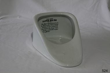 A triangular porcelain receptacle, deep at the back, and shallow at the front. 