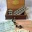 An oblong wooden box with hinged  lid containing equipment for making capsules and cachets. 