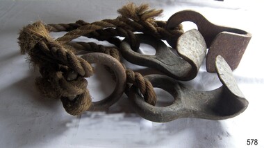 Three iron hooks each on a short length of rope, all joined to a metal ring