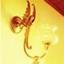 Shining lamp with angelic figure on bracket