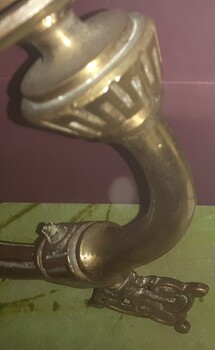 Decorative detail impressed in bracket and lamp base