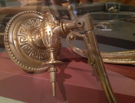 Bracket base has sperical boarder around circumference, geometric  pattern around centre.