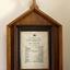 Document, framed in wood, listing many of the donors for items in the chapel