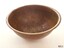 The copper bowl or ewer has a rolled lip and slightly textured surface
