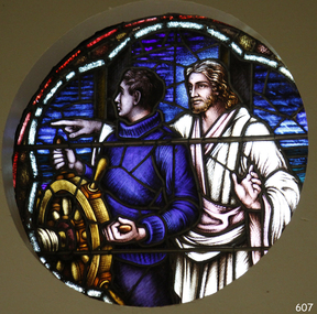 Round stained glass windows with maritime and religious themee