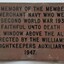 Brass plaque with text, referring to the window
