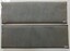 A pair of fabric covered blue-gray rectangular padded mats