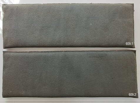 A pair of fabric covered blue-gray rectangular padded mats