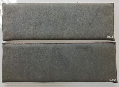 A pair of fabric covered blue-gray rectangular padded mats