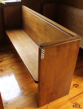 This pew is adjacent to the south wall and next to the window.