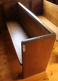 Pew is located adjacent to the south wall.