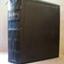 Black leather covered book with gold embossed letters on spine and a blue page marker ribbon