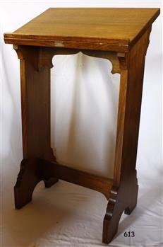 Wooden lectern with decorative brace below slanted top, and decorative finish on both legs