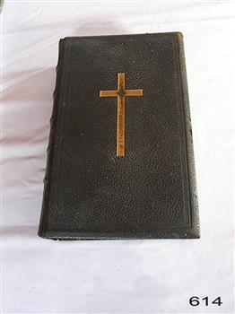 Black textured cover has an emblem of a gold crosss