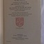 White paper with black printed text and emblem