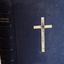 Textured black leather cover has embossed text on spine and front. The spine has five decorative horizontal lines