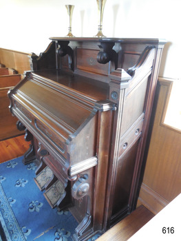 Stained and polished tall rectangular panel fits below the top shelf to the floor