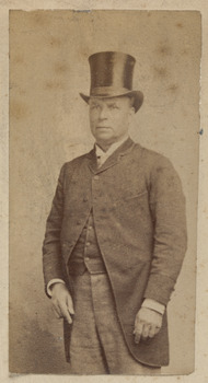 Man formally dressed with top hat, jacket and waistcoat