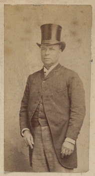Man in formal dress including top had and waistcoat