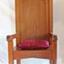 Large, tall timber armchair with inverted 'V' top on backrest and decorative cut-out design at the apex