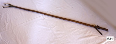 Long cane handle, pinching or grabbing tool at one end and a lever handle at the other end