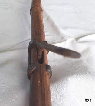 Metal mechanism is inserted into a hole in the cane and fixed into place