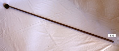 Long wooden handle with metal cap on the end.