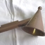 Snuffer is joined onto the wooden handle by a metal tube.