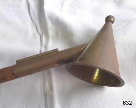 Snuffer is joined onto the wooden handle by a metal tube.