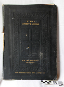 Dark hard cover has impressed pattern and gold embossing