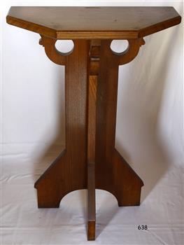 Wooden pedestal with four legs and top that is half an octagon, made to fit against a wall